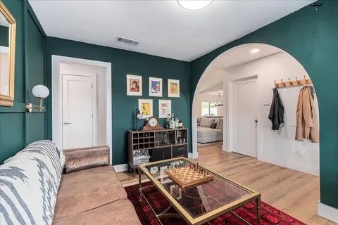a living room with furniture and a wooden floor