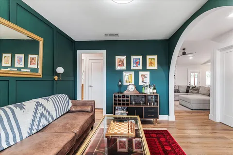 a living room with furniture and wooden floor