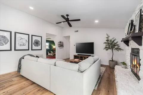 a bedroom with furniture and a flat screen tv