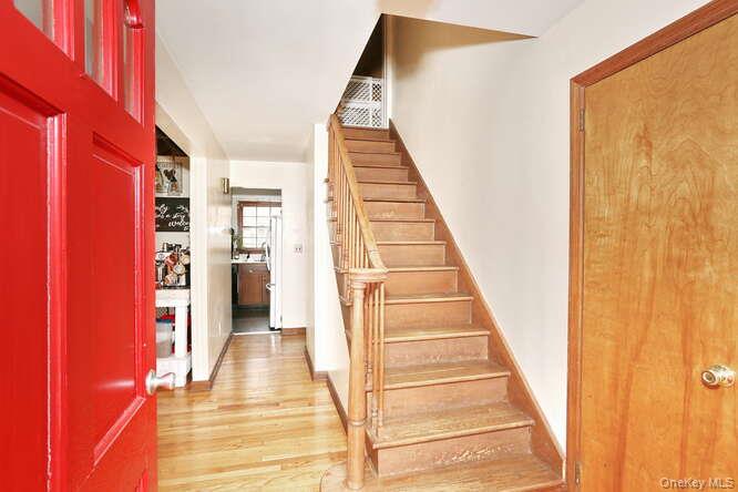 161 McNamara Road Spring Valley, NY 10977 - Photo 5 of 38 a view of a hallway with wooden floor and staircase