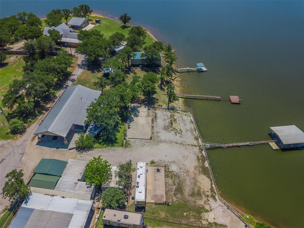 566 Selma Park Road Bowie, TX 76230 - Photo 40 of 40 Extensive waterfront property featuring multiple structures, private docks, mature trees, and a substantial boat house