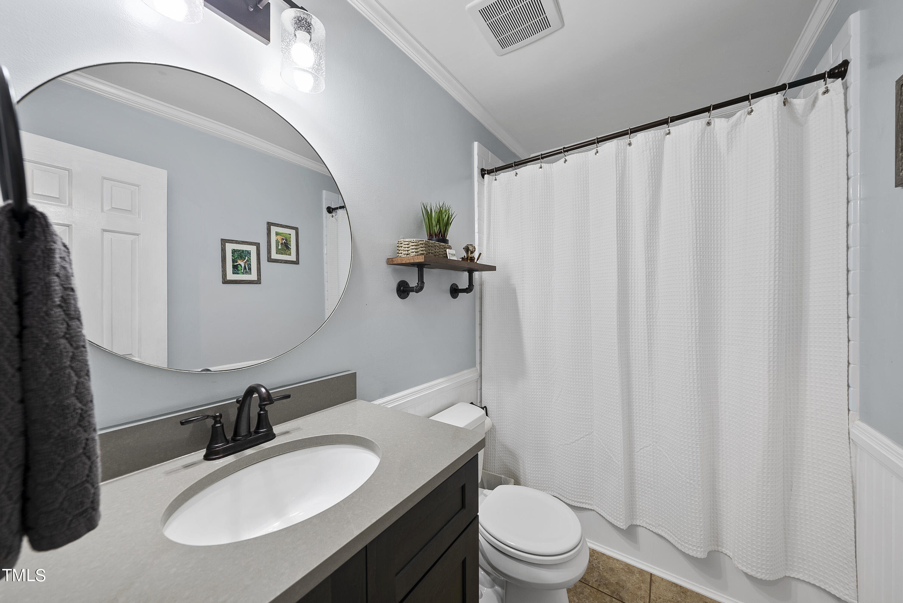 3116 Carovel Court Raleigh, NC 27612 - Photo 14 of 25 a bathroom with a sink vanity mirror and toilet