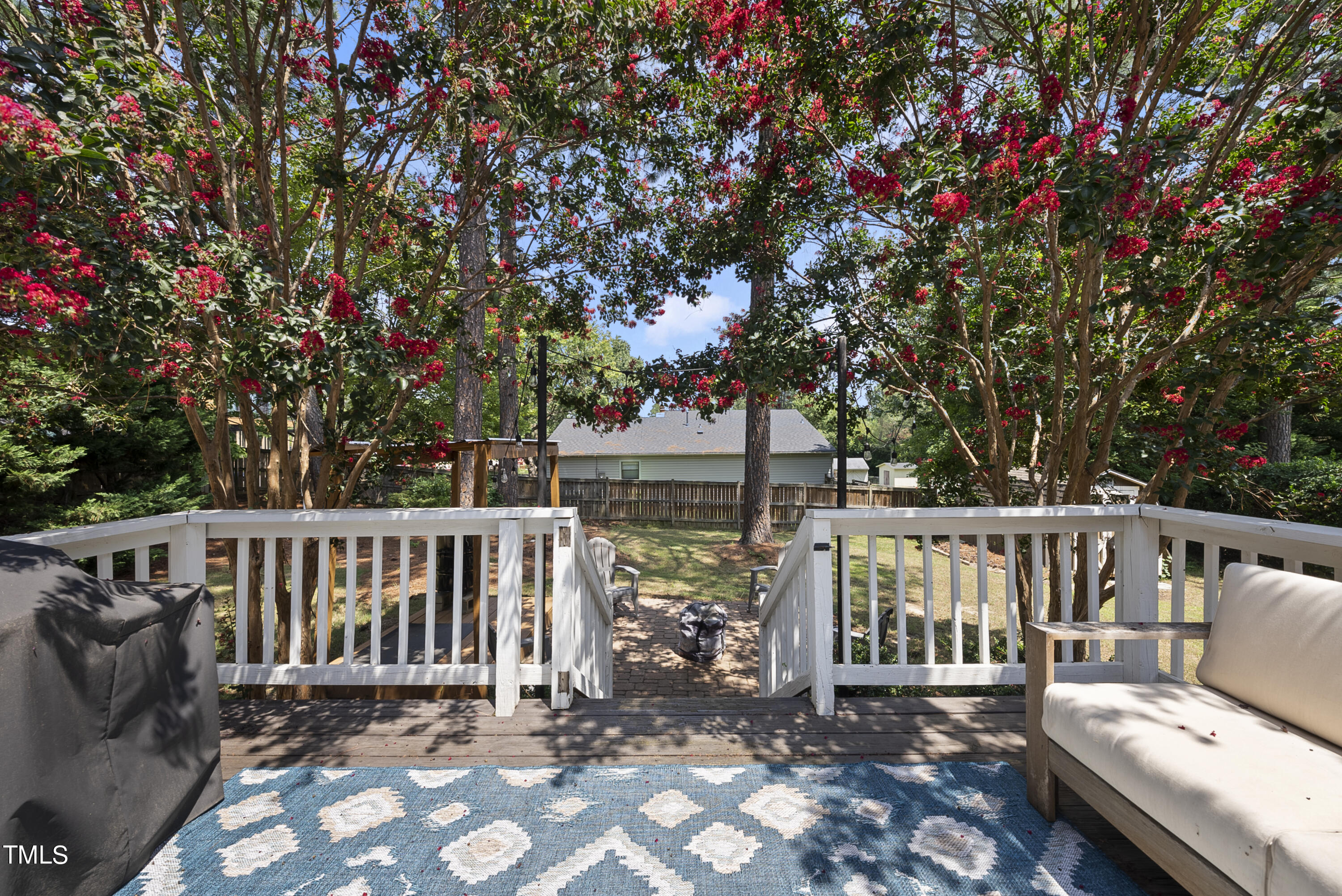 3116 Carovel Court Raleigh, NC 27612 - Photo 21 of 25 a view of a deck with a table and chairs next to a yard