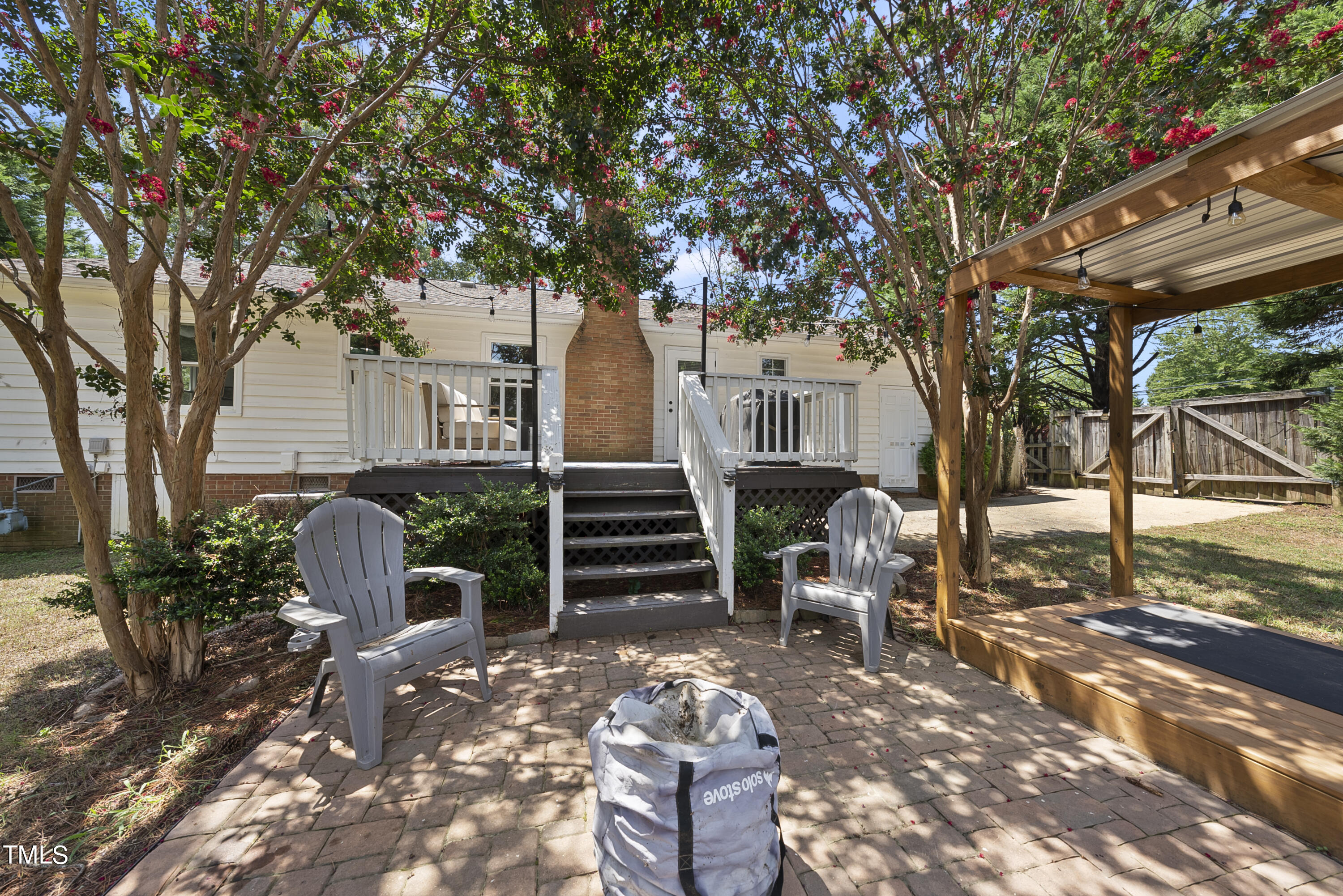 3116 Carovel Court Raleigh, NC 27612 - Photo 23 of 25 a front view of a house with garden and seating area