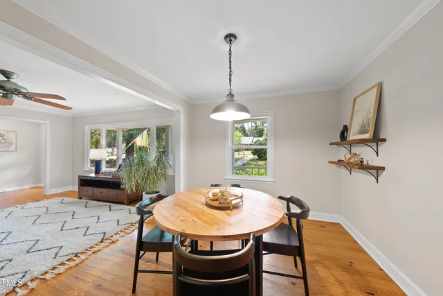 a view of a dining room with furniture window and wooden floor