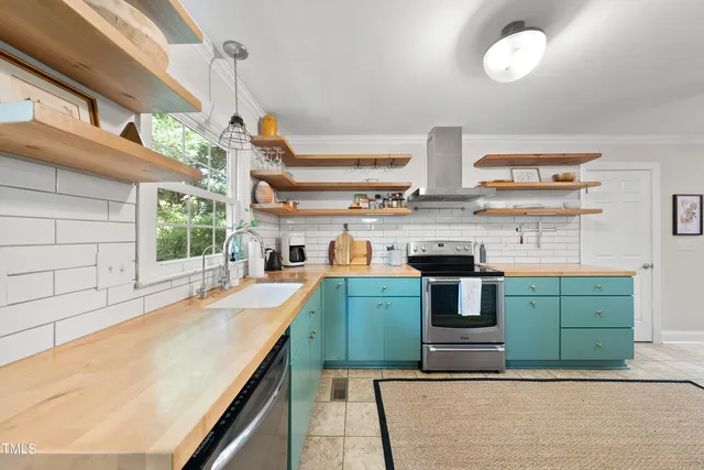 a kitchen with cabinets a stove and a sink