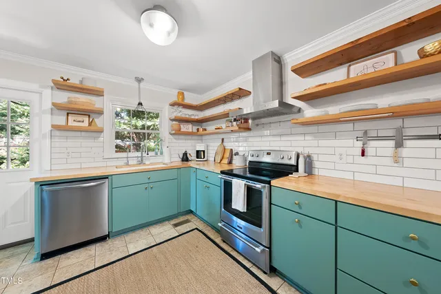 a kitchen with stainless steel appliances granite countertop a sink and stove