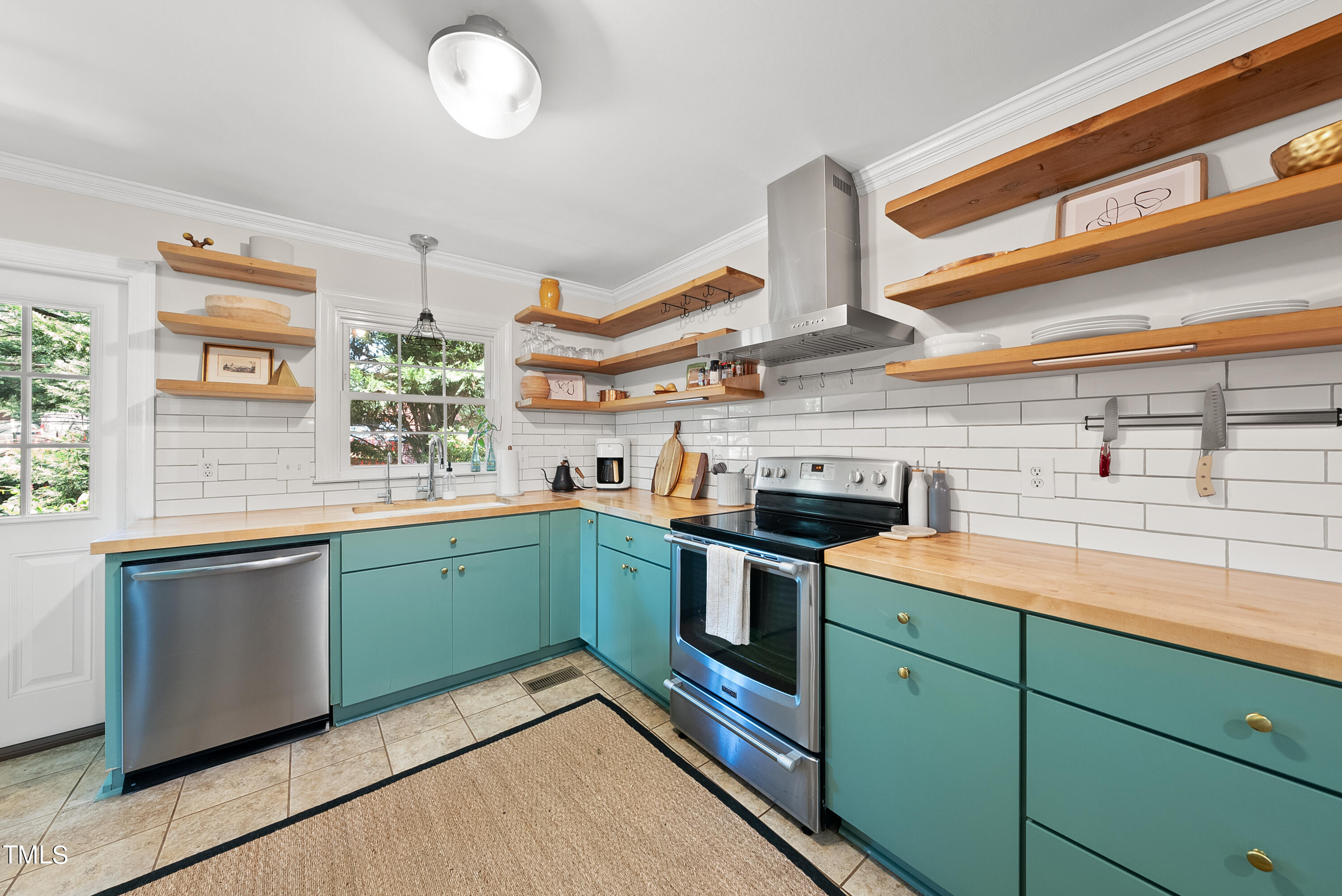 3116 Carovel Court Raleigh, NC 27612 - Photo 10 of 25 a kitchen with stainless steel appliances granite countertop a sink and stove