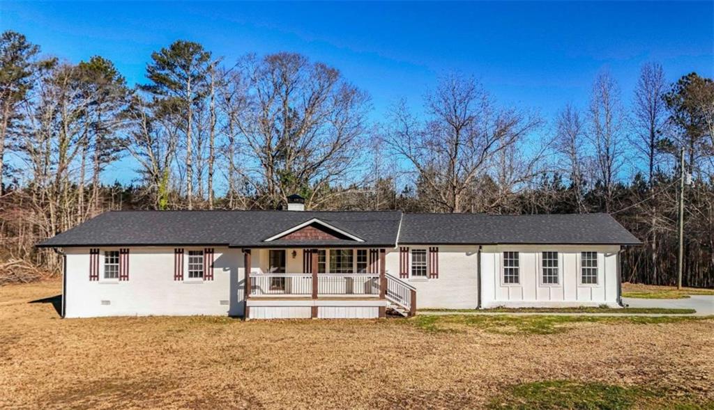 6954 Highway 120 Bremen, GA 30110 - Photo 1 of 1 a house with trees in front of it