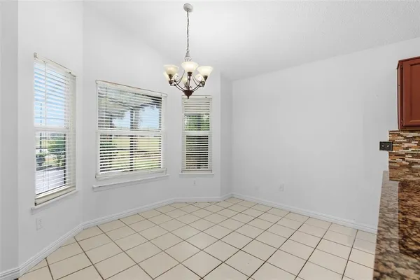 a kitchen with kitchen island white cabinets and black appliances