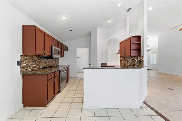 a kitchen with granite countertop a sink and cabinets