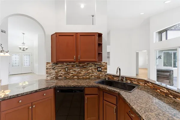 a kitchen with stainless steel appliances granite countertop a stove microwave and sink