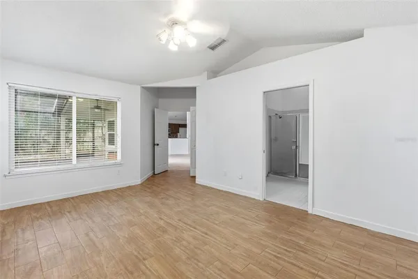 a bathroom with a bathtub a double vanity sink and mirror
