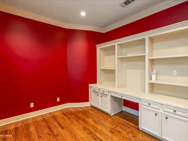 a kitchen with stainless steel appliances a cabinets and wooden floor