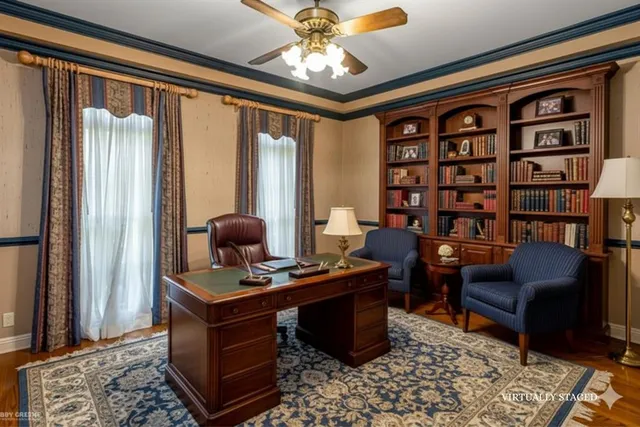 a view of a workspace with furniture and a window