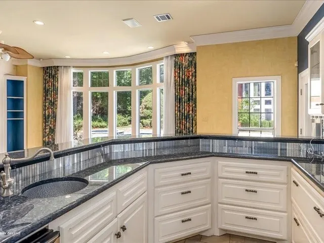a kitchen with granite countertop a sink and a granite counter tops