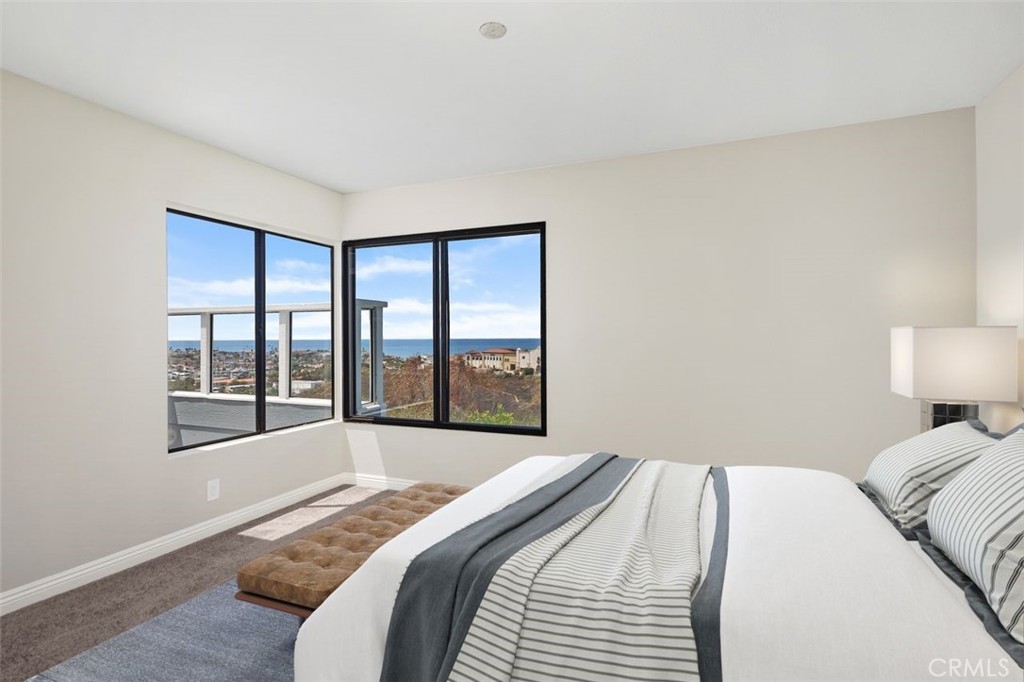 2031 Via Concha San Clemente, CA 92673 - Photo 11 of 29 a bedroom with a large bed and a large window