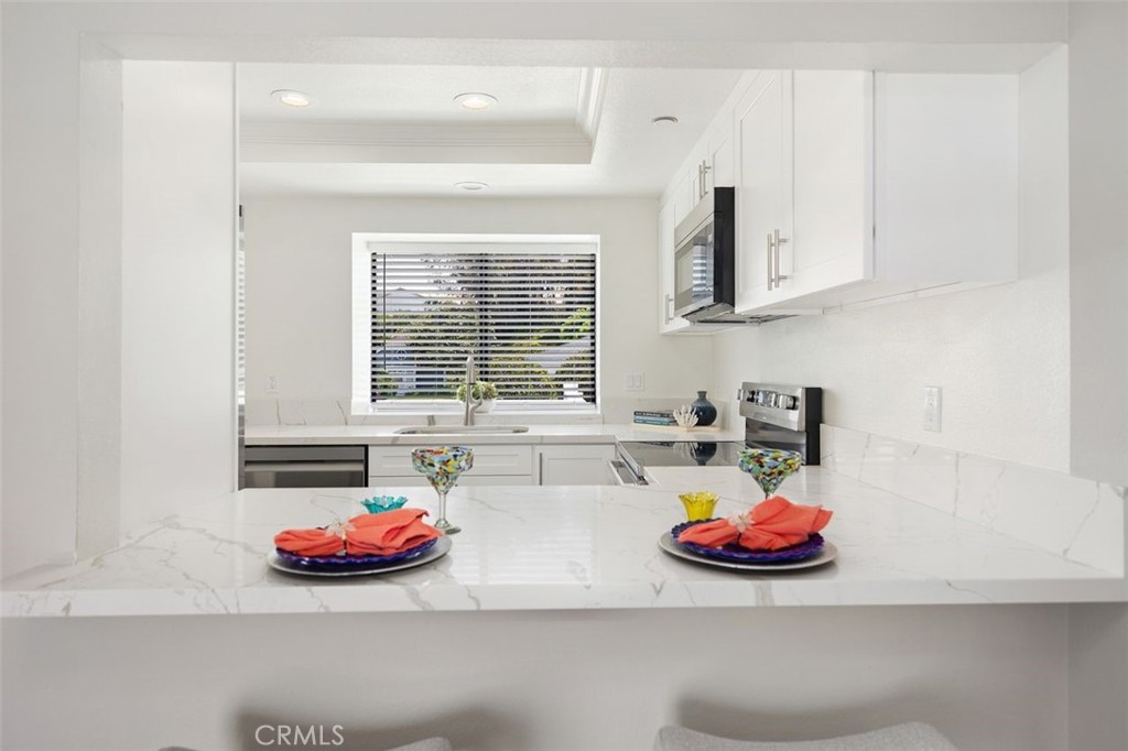 2031 Via Concha San Clemente, CA 92673 - Photo 3 of 29 a view of a kitchen with two sinks and a stove next to a window