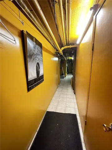 a bedroom with a bed a couch and a flat screen tv