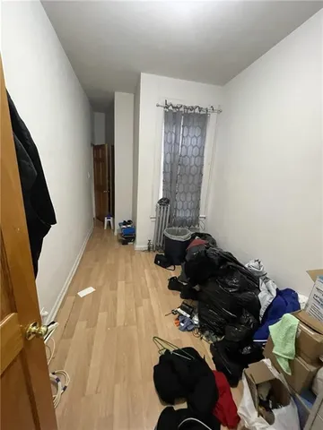 a kitchen with stainless steel appliances a white stove top oven and a wooden floor