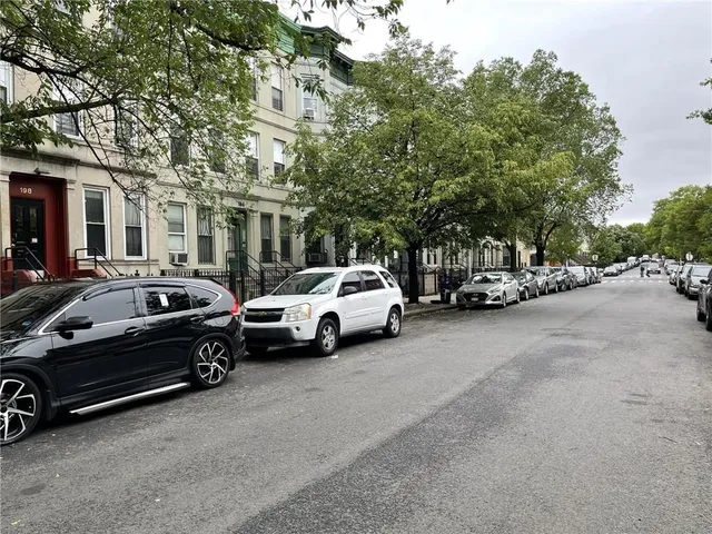 a view of cars parked in front of a house