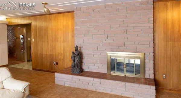 a view of a hallway with wooden floor and a fireplace