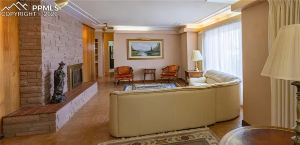a living room with fireplace furniture and a window