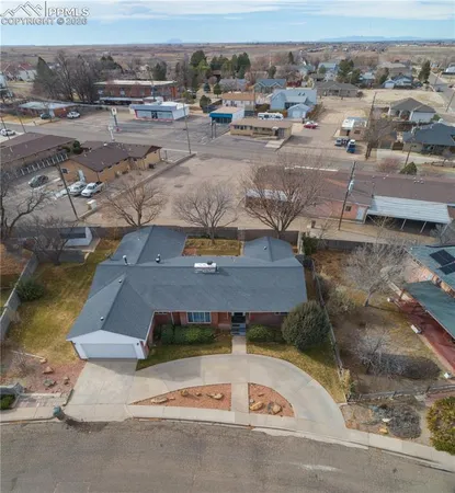 an aerial view of a house with a yard