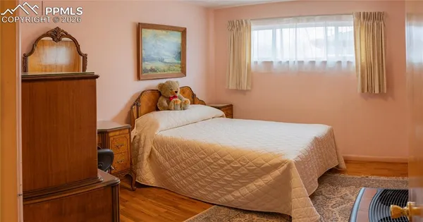 a bedroom with bed and a window