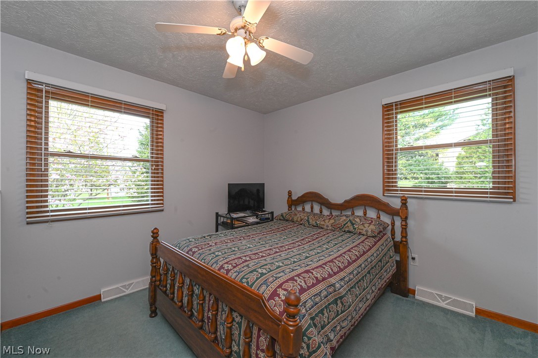 13425 Chardon-Windsor Road Chardon, OH 44024 - Photo 33 of 50 Bedroom with a textured ceiling, ceiling fan, and carpet