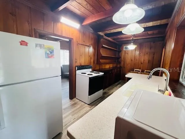 a kitchen with a refrigerator and a sink