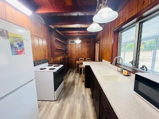 a large white kitchen with a large window