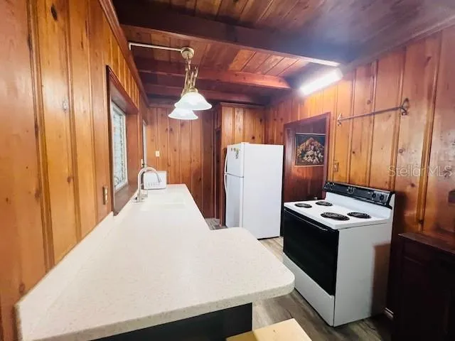 a kitchen with refrigerator and table