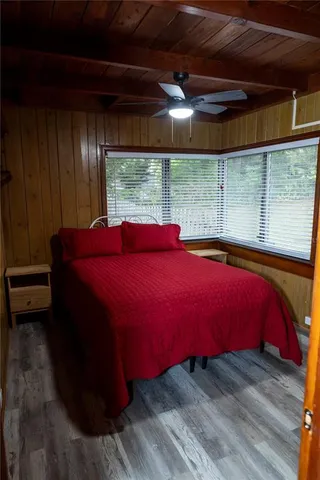 a bed sitting in a bedroom next to a window