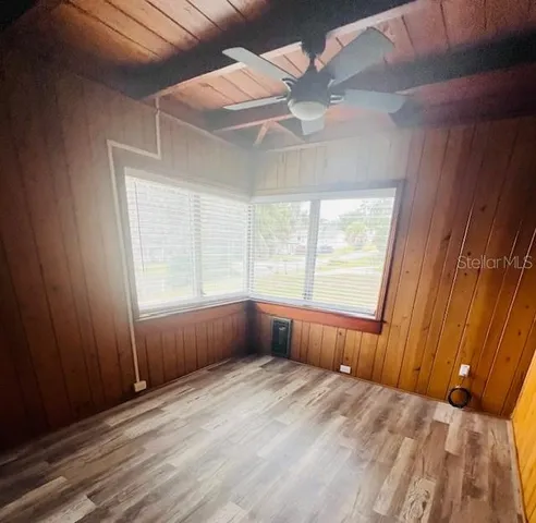wooden floor in an empty room with a window