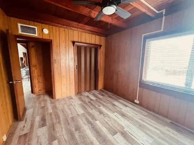 a view of a room with a bed and windows