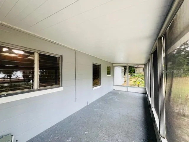 a view of a hallway to a livingroom with furniture