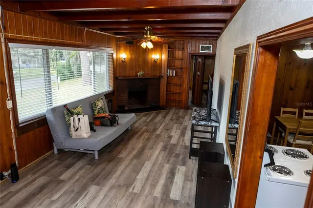 a view of a hallway with couch and chandelier
