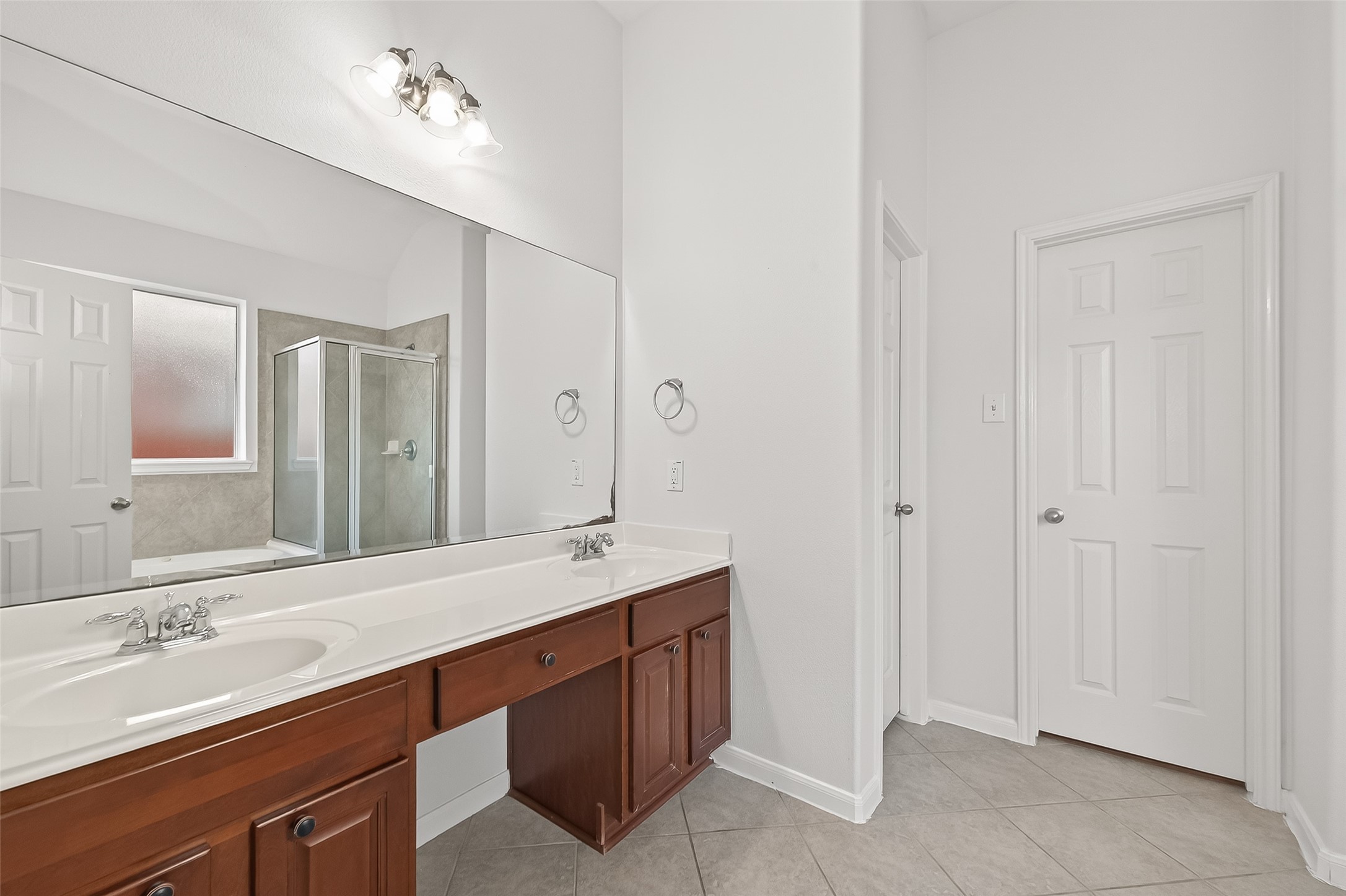 5103 Azalea Meadow Lane Katy, TX 77494 - Photo 14 of 34 a bathroom with a double vanity sink and a mirror