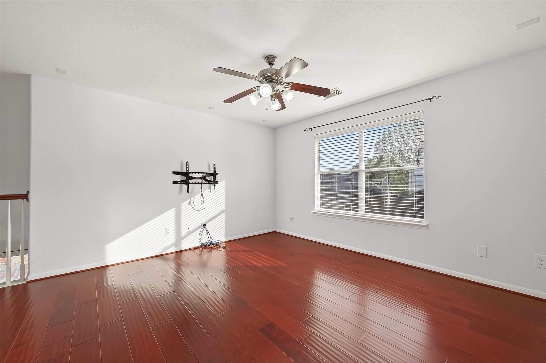 5103 Azalea Meadow Lane Katy, TX 77494 - Photo 16 of 34 a view of a room with wooden floor chandelier fan and windows