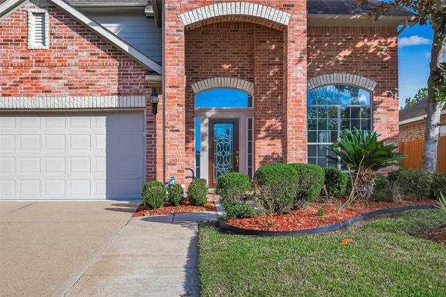 a front view of a house with garden