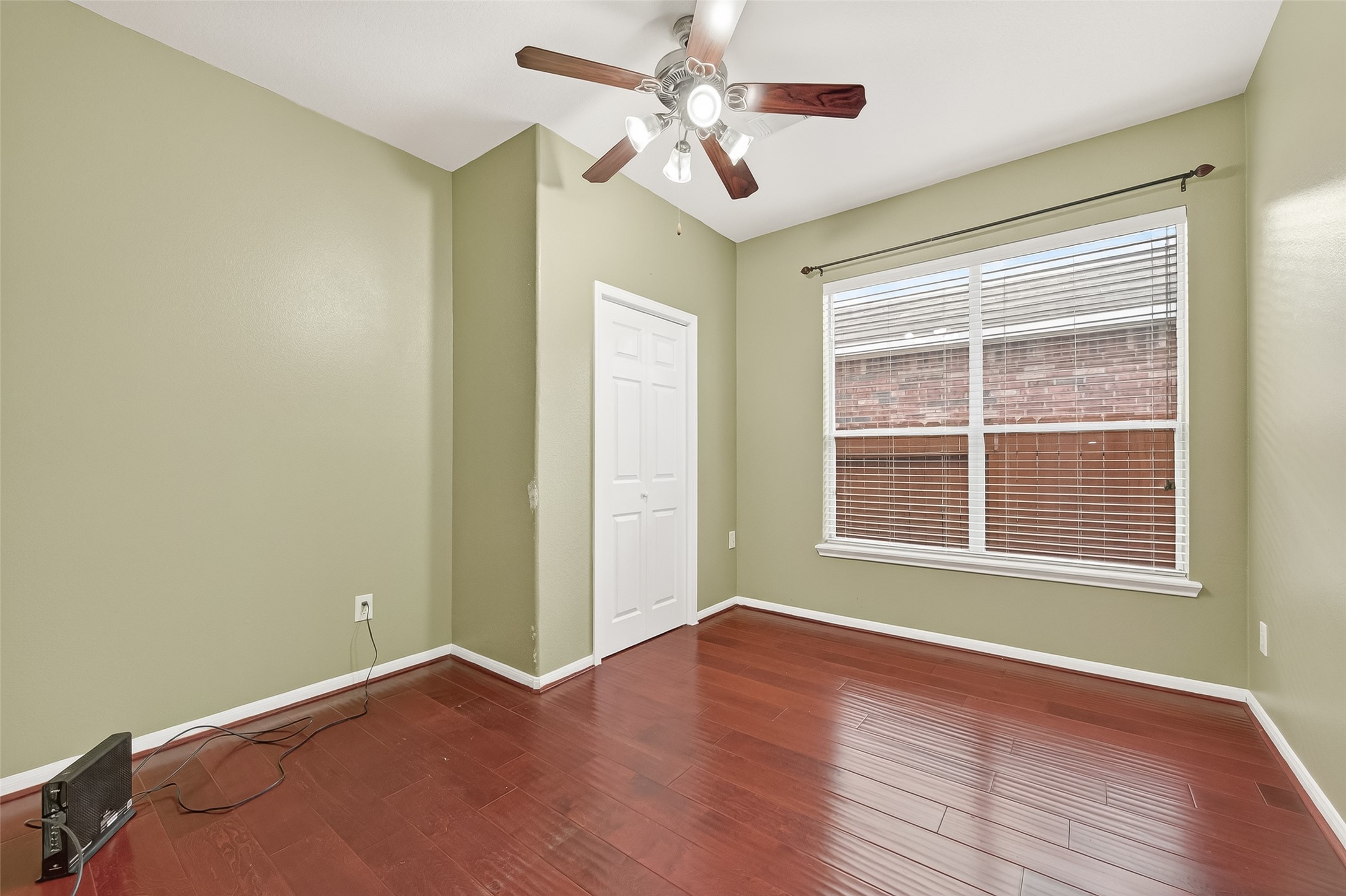 5103 Azalea Meadow Lane Katy, TX 77494 - Photo 25 of 34 an empty room with wooden floor and windows