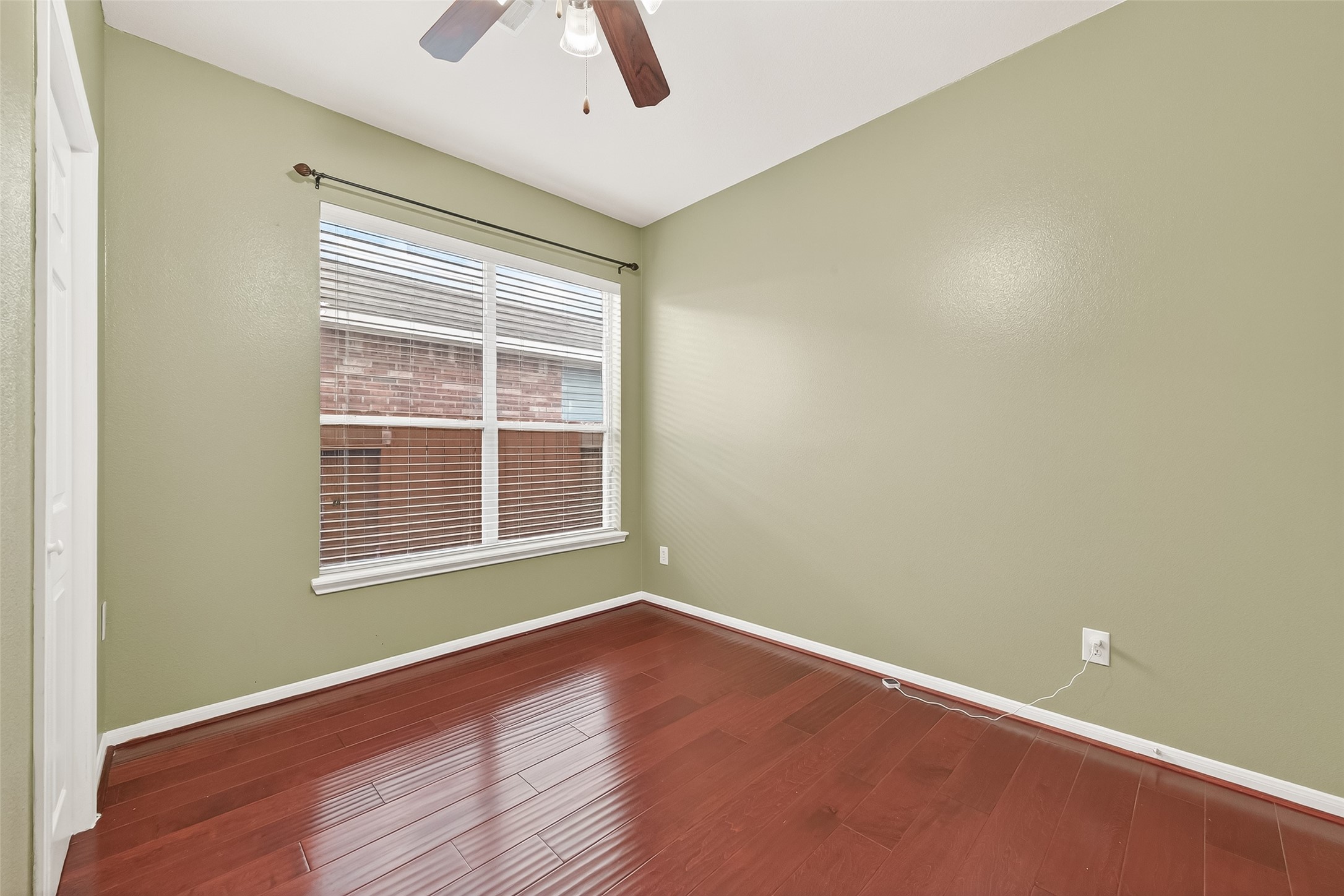 5103 Azalea Meadow Lane Katy, TX 77494 - Photo 26 of 34 an empty room with wooden floor and windows