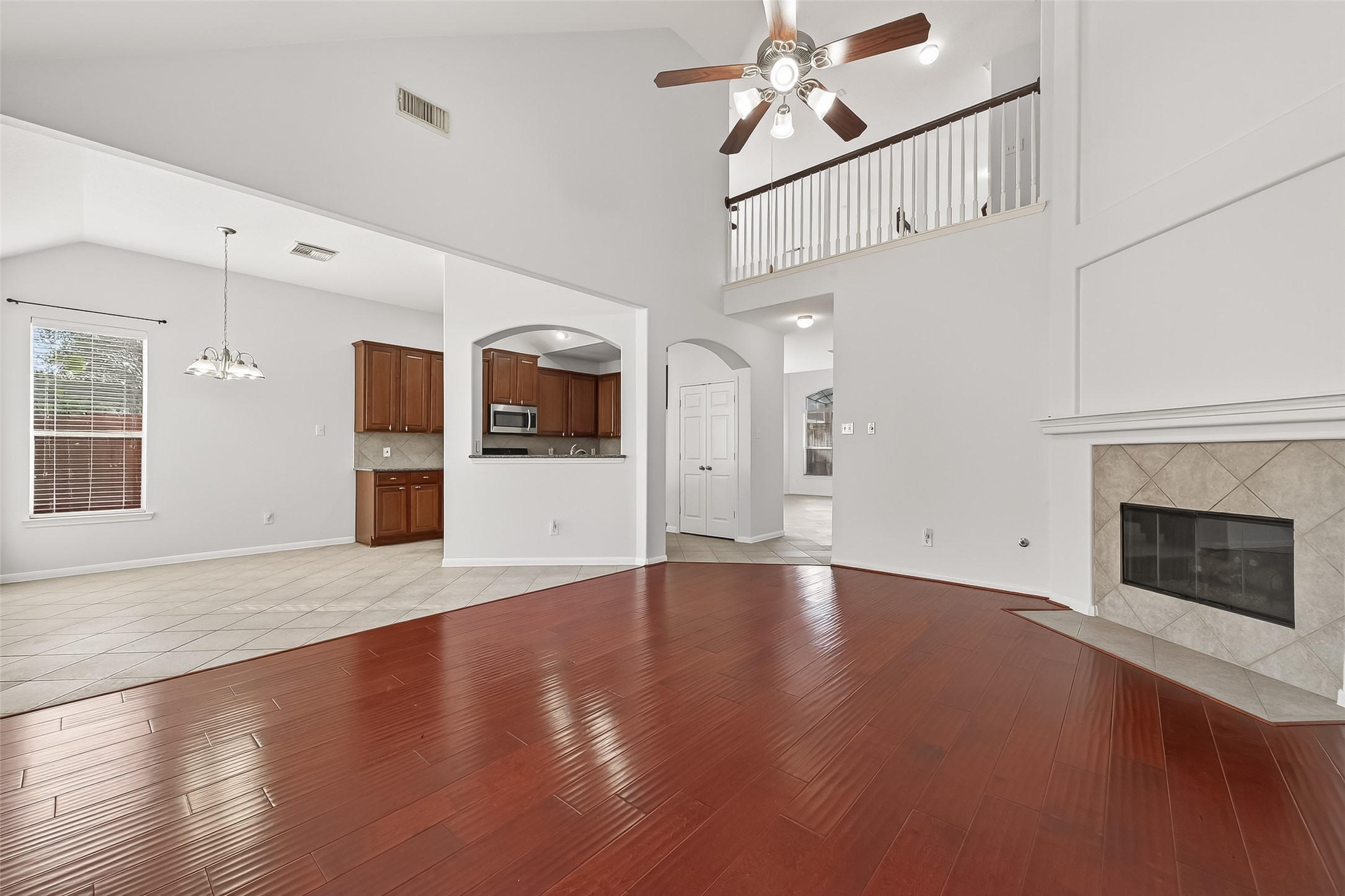 5103 Azalea Meadow Lane Katy, TX 77494 - Photo 6 of 34 a view of a livingroom with wooden floor and a kitchen