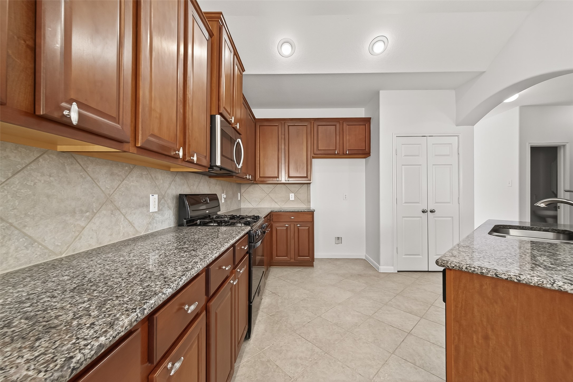 5103 Azalea Meadow Lane Katy, TX 77494 - Photo 9 of 34 a kitchen with stainless steel appliances granite countertop a sink stove and refrigerator
