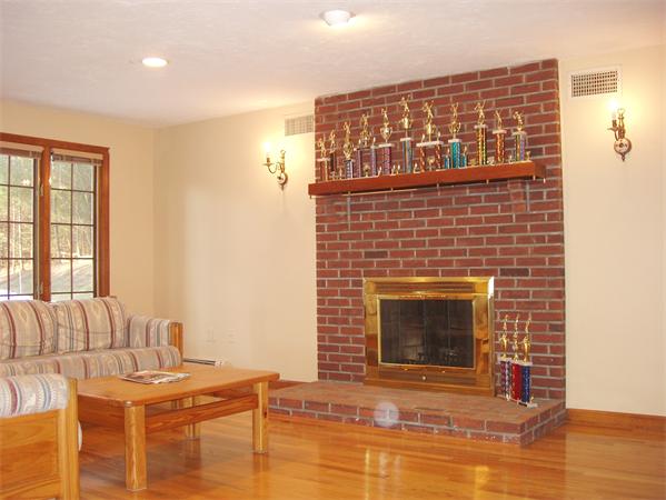 65 Virginia Ridge Road Sudbury, MA 01776 - Photo 6 of 29 a living room with furniture a fireplace and a table