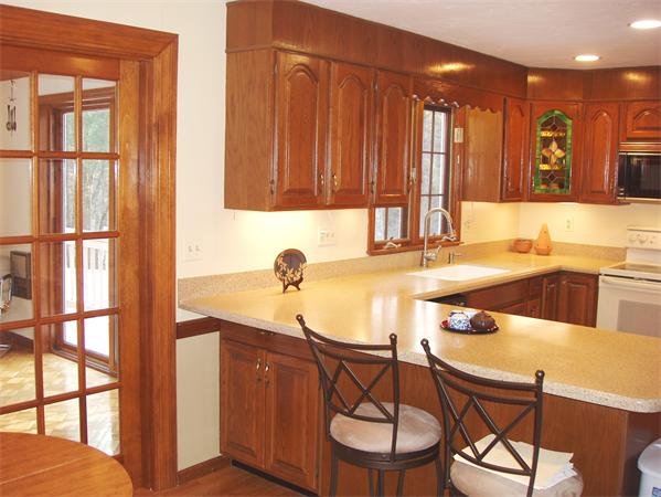 65 Virginia Ridge Road Sudbury, MA 01776 - Photo 8 of 29 a kitchen with a table chairs and a swimming pool