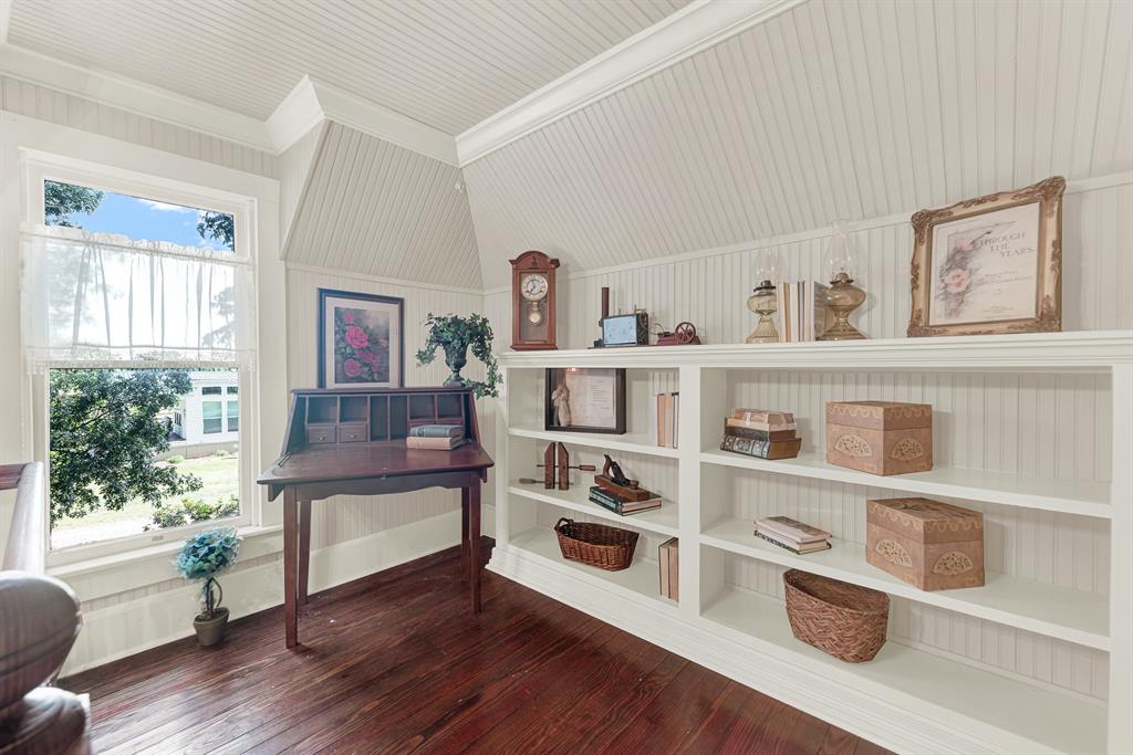 1425 Lone Star Road Celina, TX 75009 - Photo 17 of 40 Custom built-in bookshelves, beadboard walls, and abundant natural light create a cozy library that feels both timeless and inviting. Spend a quiet afternoon surrounded by favorite books, or enjoy a peaceful workspace tucked away from the rest of the home.