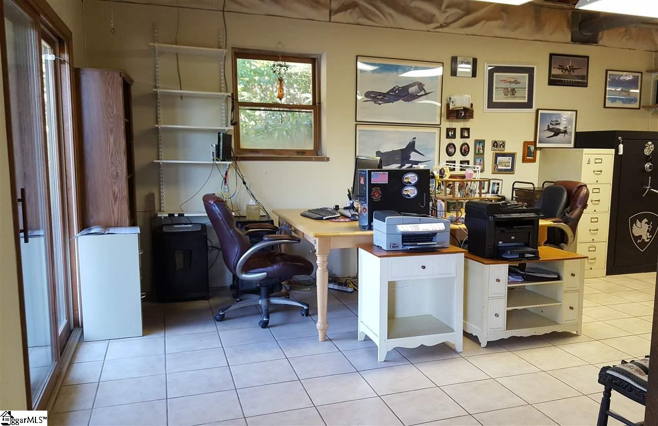 2875 Table Rock Road Pickens, SC 29671 - Photo 20 of 36 Office is located in basement, because of the location this home is perfect for your home office or you could convert this to a fourth bedroom. There's plenty of natural light due to the window and twin sliders.