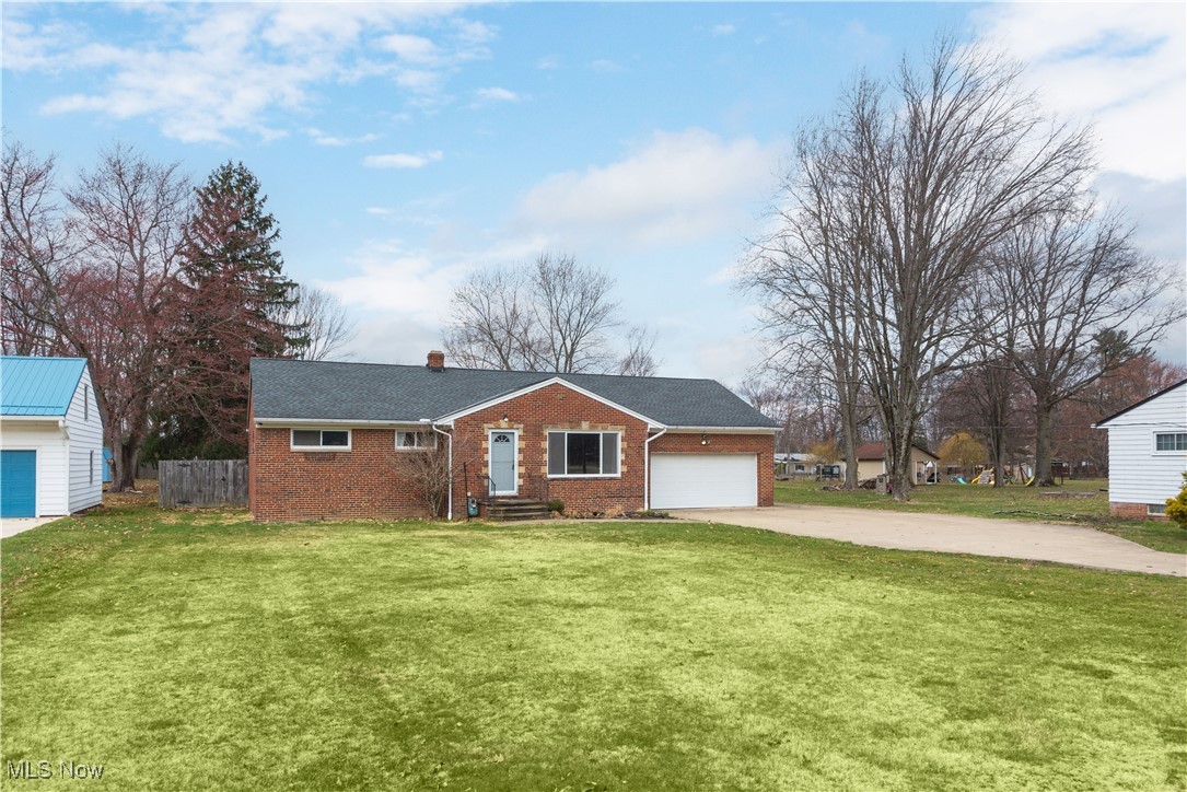 11518 Prospect Road Strongsville, OH 44149 - Photo 45 of 46 Ranch-style home with driveway, an attached garage, fence, brick siding, and a front lawn